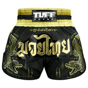 Black and gold Muay Thai shorts with dragon designs and TUFF PAYAK branding.