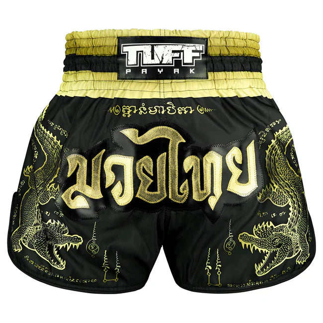 Black and gold Muay Thai shorts with dragon designs and TUFF PAYAK branding.