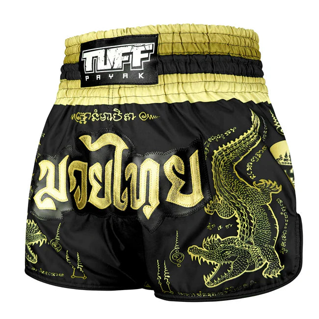 Black and gold Muay Thai shorts with crocodile design and TUFF PAYAK branding.