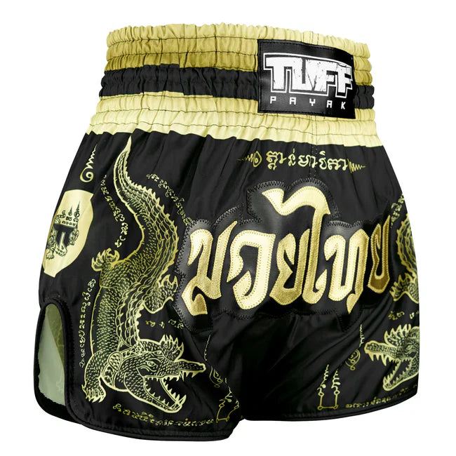 Black and gold Muay Thai shorts with dragon design and TUFF label on a white background