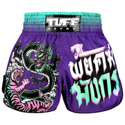 Purple Thai boxing shorts with dragon and tiger design and 'TUFF' branding on a white background