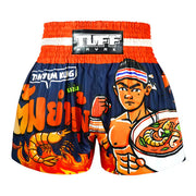 Colourful Muay Thai shorts with a character holding a bowl of soup and text on a white background.